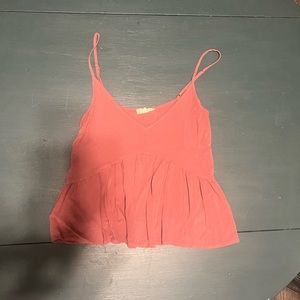 Flirty little spaghetti strap camisole with ruffled body.